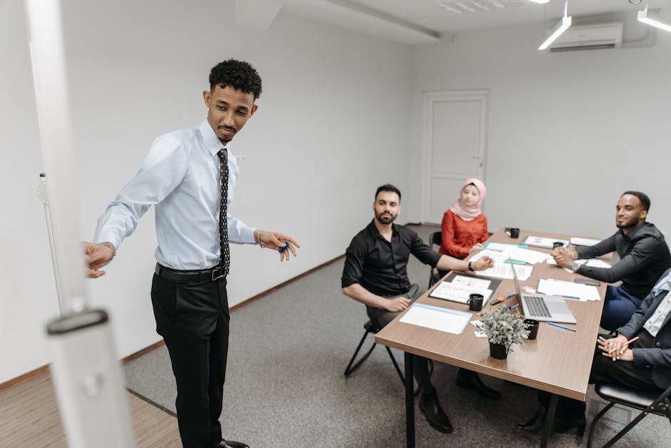 A diverse team collaborates in a modern office setting, showcasing teamwork and communication.